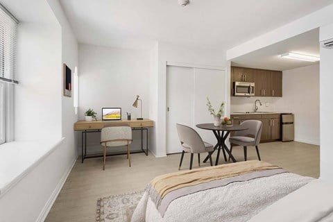 A modern living room with a dining table and chairs.